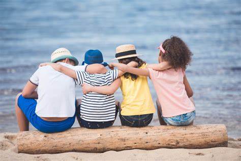 Friends sitting with arms around one another